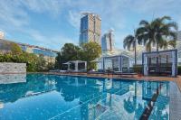 a large swimming pool with a city skyline in the background at PARKROYAL COLLECTION Marina Bay, Singapore in Singapore