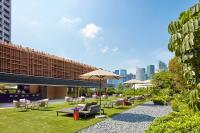 a patio with chairs and tables and umbrellas at PARKROYAL COLLECTION Marina Bay, Singapore in Singapore