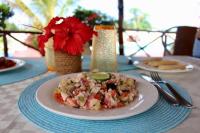 a table with a plate of food on a table at Villa Francesca Boutique Hotel in Uroa