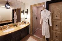 a bathroom with two sinks and a large mirror at Jumeirah Mina Al Salam Dubai in Dubai