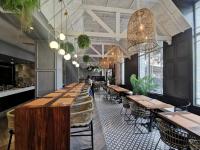 a row of tables and chairs in a restaurant at ONOMO Hotel Cape Town – Inn On The Square in Cape Town