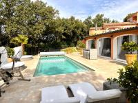 a swimming pool with chairs and a house at La Casa dei Sogni in Flayosc
