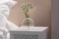 a vase with flowers in it on a table at Hôtel Plaza Étoile in Paris