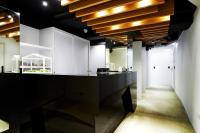 a kitchen with a black counter and wooden ceilings at Forever Inn in Taipei