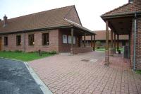 a brick building with a brick driveway in front of it at Hôtel Les Charmilles de Mormal in Landrecies