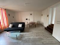 a living room with a black couch and a table at Appartement La Roche-Posay, 2 pièces, 5 personnes - FR-1-541-40 in La Roche-Posay