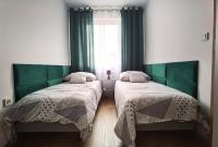 Posteľ alebo postele v izbe v ubytovaní Apartament Olecko Centrum