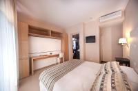 Łóżko lub łóżka w pokoju w obiekcie Hotel Carla