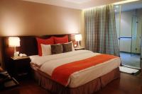 a bedroom with a large bed with red pillows at Aqua Bella Hotel in Taipei