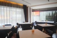 a dining room with tables and chairs and a window at Aqua Bella Hotel in Taipei