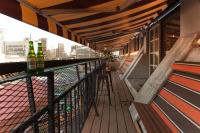 a balcony with bottles of beer and a bar at Ximen Wow Hostel in Taipei