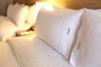 two white pillows on a bed in a room at KUN Hotel in Taichung