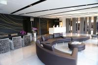 a lobby with couches and tables in a building at KUN Hotel in Taichung