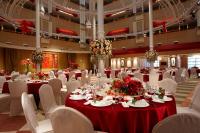 a large banquet hall with tables and white chairs at Chateau de Chine Xinzhuang in Xinzhuang
