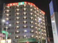 a tall building with lights on it at night at Centre Hotel in Kaohsiung