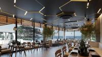 a dining room with tables and chairs and lights at Hotel Indigo - Galapagos by IHG in Puerto Baquerizo Moreno