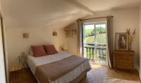 a bedroom with a bed and a large window at Amama Baita in Urrugne