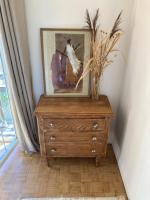 a wooden dresser with a painting on top of it at Amama Baita in Urrugne