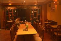 dos personas sentadas en una mesa en un restaurante en Golden Gate Guest House, en Bhaktapur