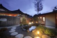 a garden with a pond in front of a house at Fuji Onsenji Yumedono in Fujikawaguchiko