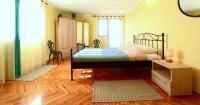 a bedroom with a bed and a wooden floor at Adriana Nova Vas in Nova Vas