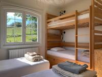 two bunk beds in a room with a window at Amama Baita in Urrugne