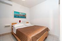 a bedroom with a bed with a painting on the wall at Apartments with a parking space Bibinje, Zadar - 18275 in Bibinje