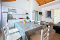 a kitchen and dining room with a table and chairs at Apartments with a parking space Bibinje, Zadar - 18275 in Bibinje