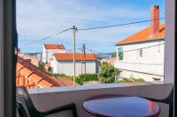 a room with a view of a city from a balcony at Apartments with a parking space Bibinje, Zadar - 18275 in Bibinje