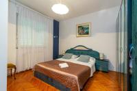 a bedroom with a bed and a large window at Apartments with a parking space Bibinje, Zadar - 18275 in Bibinje