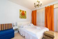 a bedroom with a bed and a blue chair at Apartments with a parking space Bibinje, Zadar - 18275 in Bibinje