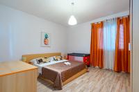 a bedroom with a bed and orange curtains and a desk at Apartments with a parking space Bibinje, Zadar - 18275 in Bibinje