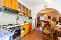 a kitchen with a stove and a dining room at Apartments with a parking space Bibinje, Zadar - 18275 in Bibinje