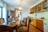 a kitchen with a table and chairs and a sink at Apartments with a parking space Bibinje, Zadar - 18275 in Bibinje