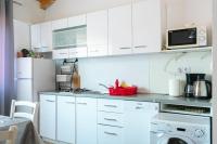 a kitchen with white cabinets and a white refrigerator at Apartments with a parking space Bibinje, Zadar - 18275 in Bibinje