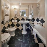 a bathroom with a sink and a toilet and a tub at Hotel Orsaria in Venice