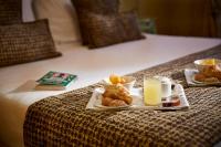 a tray of food on a bed with eggs and pastries at Hotel Orsaria in Venice