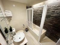 a bathroom with a toilet and a sink and a window at Jiufen Breeze 九份惠風民宿ｌ6人包棟小屋 in Jiufen