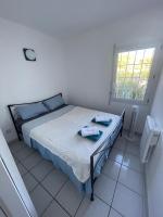 a bedroom with a bed with two towels on it at Appartement residence le nautile in Le Grau-du-Roi