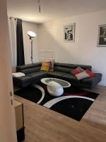 a living room with a couch and a table on a rug at Le parapluie rouge in Chalons en Champagne