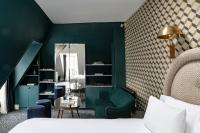 a bedroom with green walls and a bed and a mirror at Grand Pigalle Hotel in Paris