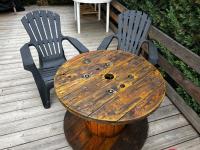 a wooden table and two chairs on a wooden deck at Embrun - Appartement 4&#47;6 personnes avec extérieurs in Embrun