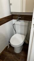 a bathroom with a white toilet in a room at Embrun - Appartement 4&#47;6 personnes avec extérieurs in Embrun