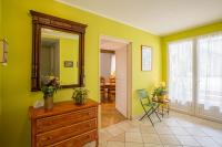 a room with yellow walls and a dresser and a mirror at CHAMBRES D&#39;HOTES 2 à 4p ou GITE DE GROUPE 15p, 7 ch, 6 sdb, parc et salle de réception in Villeneuve-de-Berg