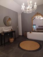 a bathroom with a tub and a sink and a mirror at Luxe-kamer Bed en Bokes 