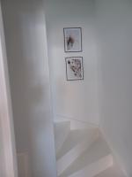 a white shower with two pictures on the wall at Luxe-kamer Bed en Bokes 