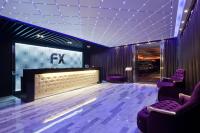 a room with purple chairs and a projection screen at FX Hotel Taipei Nanjing East Road Branch in Taipei