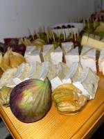 a table topped with cheese and an artichoke and onions at Hotel Bergstätter Hof in Immenstadt im Allgäu