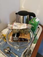 a glass plate with a cup and some food on a counter at B&amp;B Asbeek in Asse