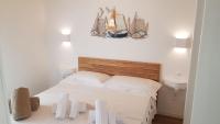 A bed or beds in a room at Agriturismo Resort Il Foionco